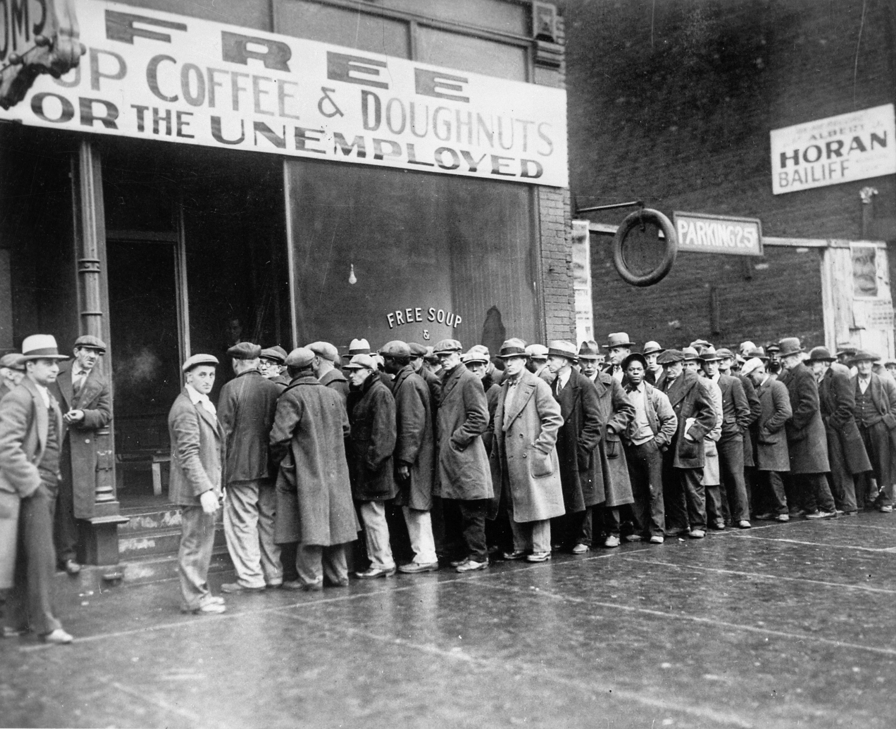 Unemployed_men_queued_outside_a_depression_soup_kitchen_opened_in_Chicago_by_Al_Capone,_02-1931_-_NARA_-_541927.jpg